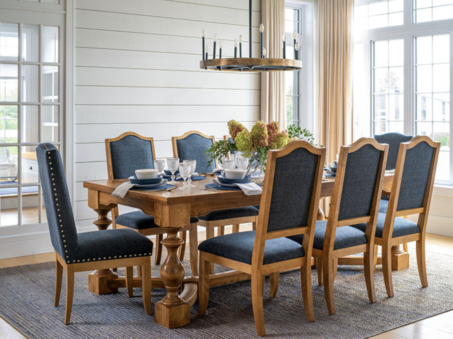 8-seat blue fabric and light wood dining table